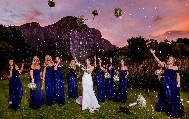 Bride spays bubbly and Bridemaids throw boquests into the air