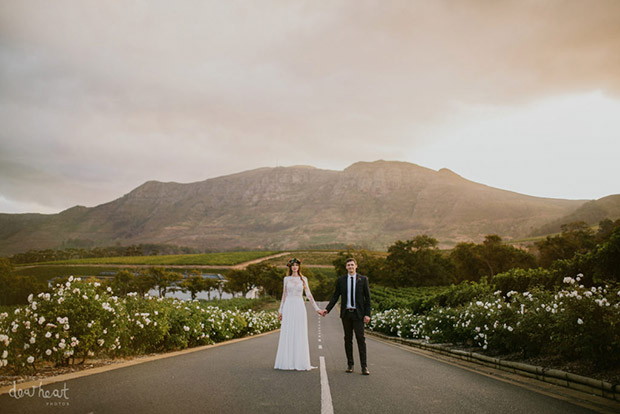 Bride and Groom with Backdrop of roses and Mountains